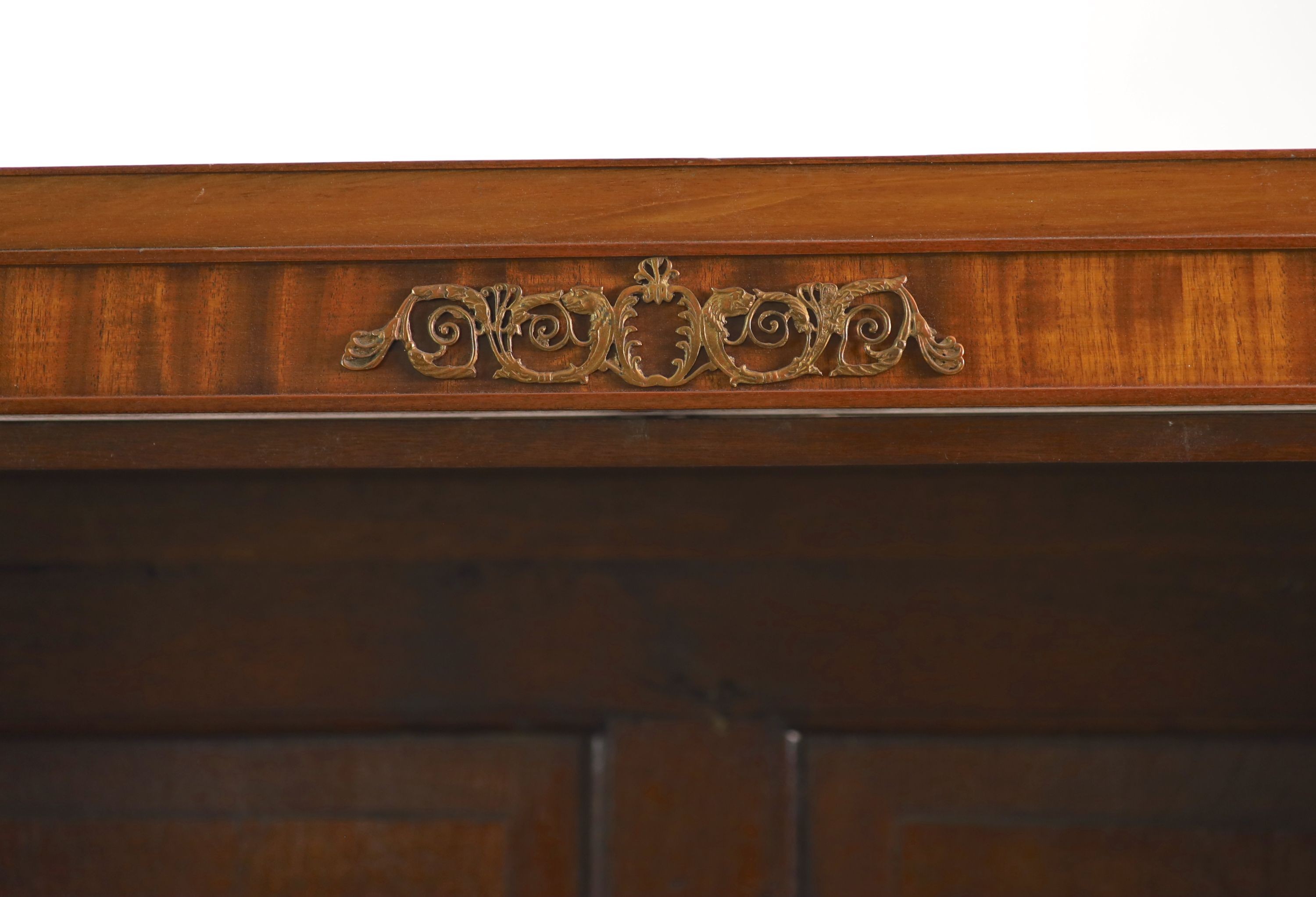 A Regency style mahogany inverse breakfront bookcase H 205cm. W 240cm. D 38cm.